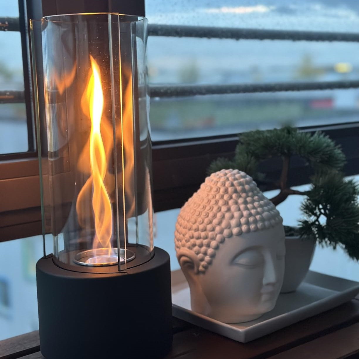 Bordpejs med åben ild i glascylinder med base og sten