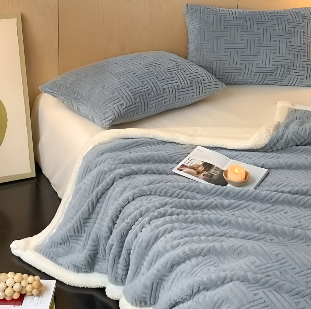 Reversible sofa blanket with embossed pattern and sherpa lining