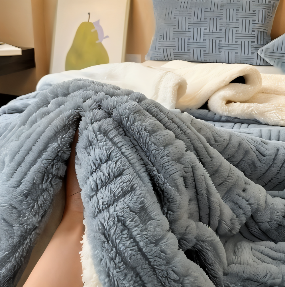 Reversible sofa blanket with embossed pattern and sherpa lining