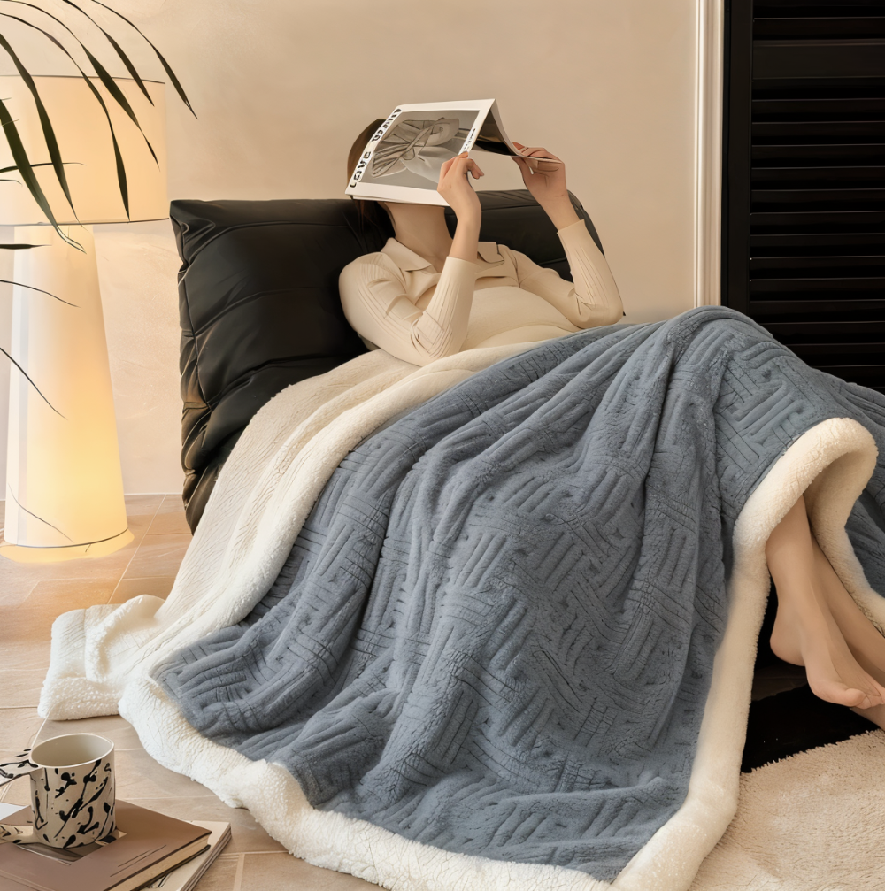 Reversible sofa blanket with embossed pattern and sherpa lining