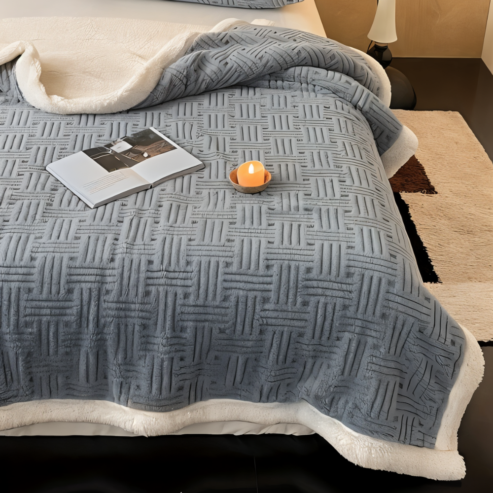 Reversible sofa blanket with embossed pattern and sherpa lining